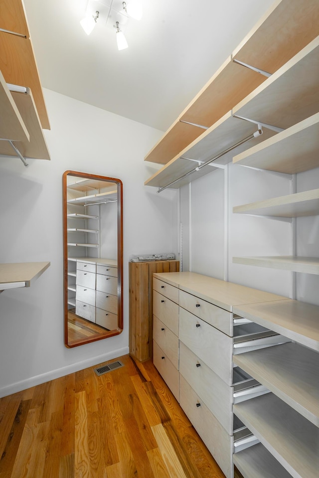 walk in closet featuring light hardwood / wood-style floors