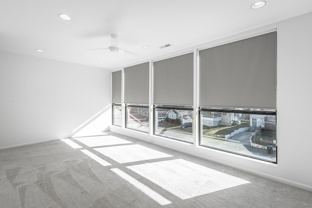 carpeted empty room featuring ceiling fan