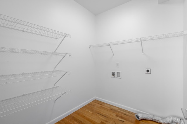 clothes washing area with hardwood / wood-style flooring, hookup for a washing machine, and electric dryer hookup