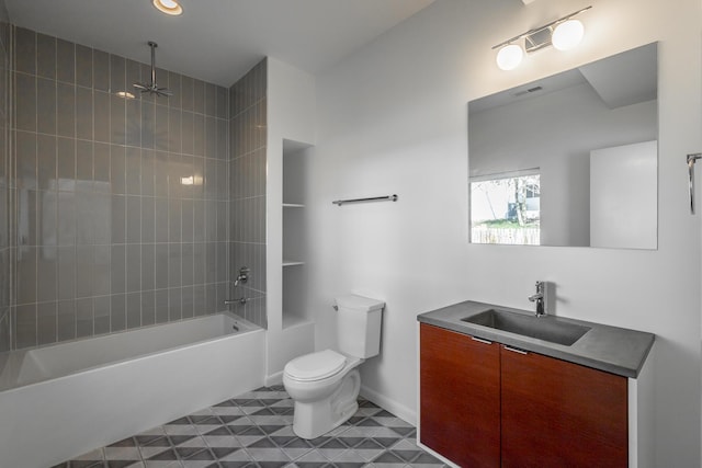 full bathroom with tiled shower / bath, vanity, and toilet