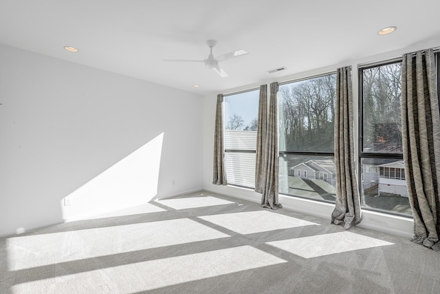 unfurnished room with ceiling fan and light colored carpet