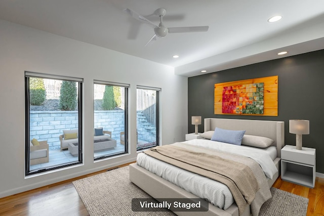 bedroom featuring light wood-type flooring, access to exterior, and ceiling fan