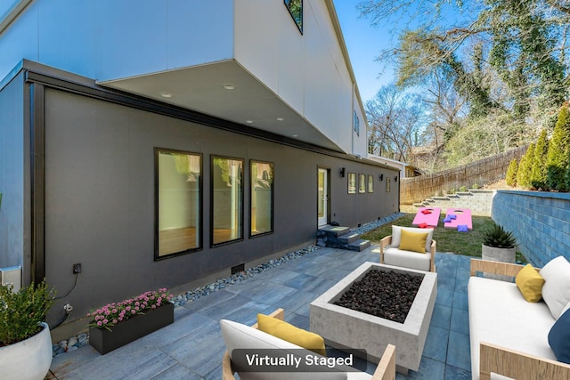 view of patio featuring an outdoor living space with a fire pit