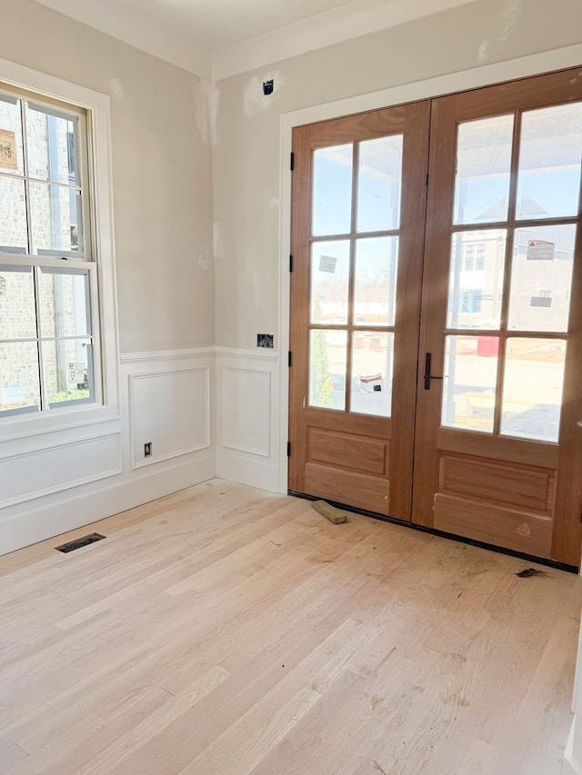 doorway to outside featuring french doors and light wood-type flooring