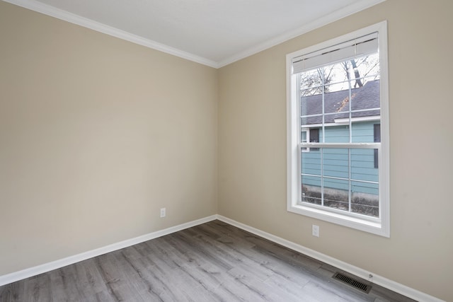 unfurnished room featuring light wood-type flooring and crown molding