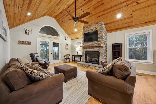 living room with a fireplace, french doors, a wealth of natural light, and wood ceiling