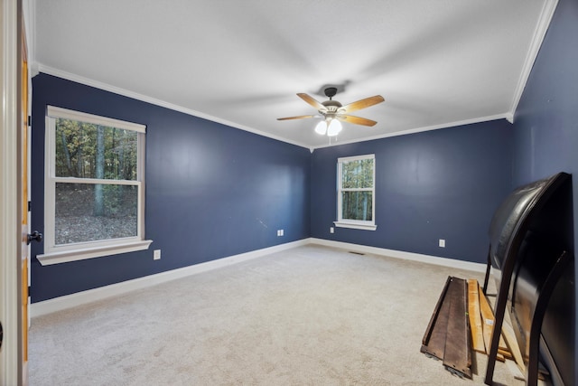 interior space featuring light colored carpet, ceiling fan, and ornamental molding