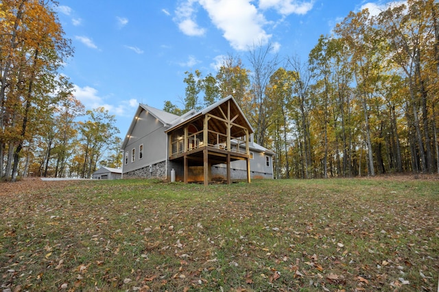 rear view of property with a lawn and a deck