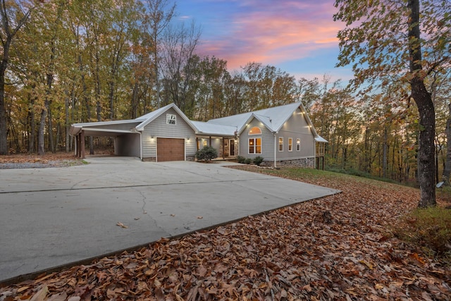 ranch-style house featuring a garage and a carport