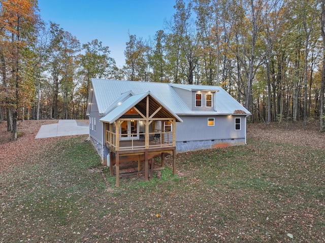 rear view of house featuring a yard