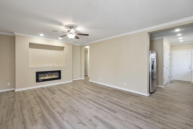 unfurnished living room featuring a textured ceiling, ceiling fan, light wood-type flooring, and ornamental molding