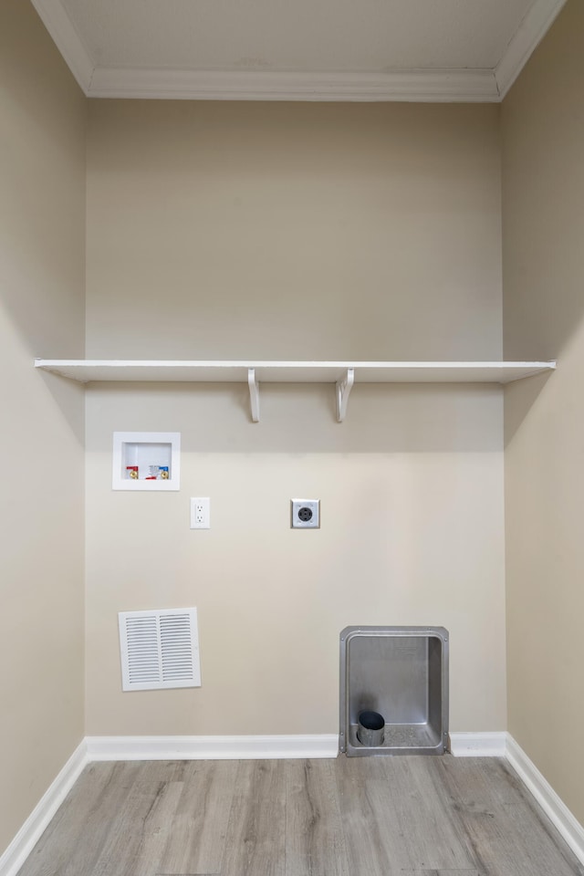 washroom with crown molding, hookup for a washing machine, and light hardwood / wood-style floors