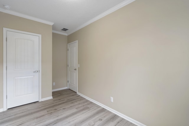 unfurnished bedroom with light hardwood / wood-style flooring and ornamental molding