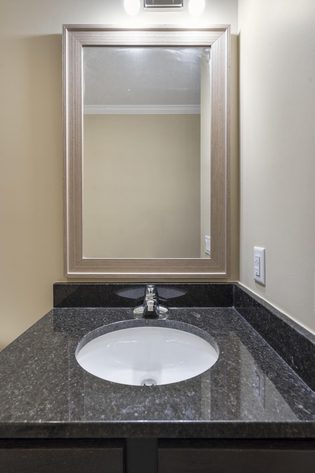 bathroom with crown molding and vanity