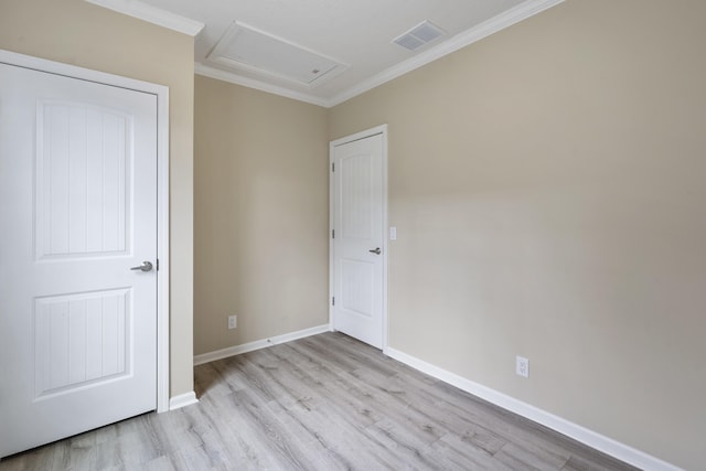 unfurnished room with crown molding and light wood-type flooring