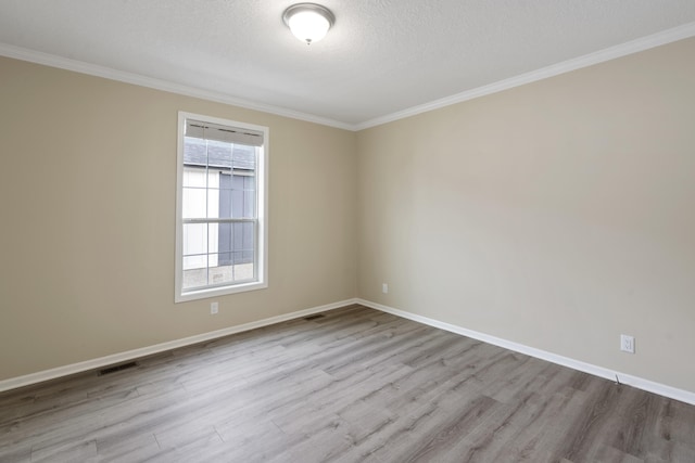 unfurnished room with a textured ceiling, crown molding, and light hardwood / wood-style flooring