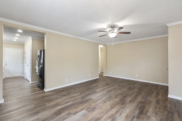 spare room with a textured ceiling, dark hardwood / wood-style floors, ceiling fan, and crown molding