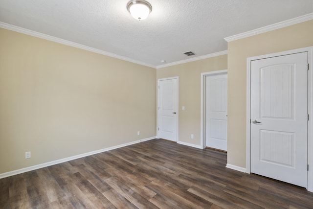 unfurnished bedroom featuring a textured ceiling, dark hardwood / wood-style flooring, and crown molding