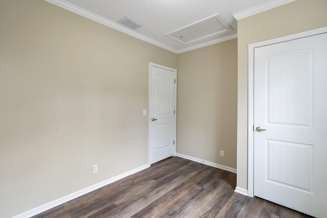 spare room featuring a textured ceiling, crown molding, and dark wood-type flooring