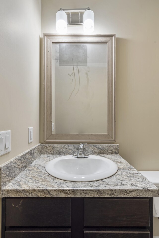 bathroom featuring vanity and toilet