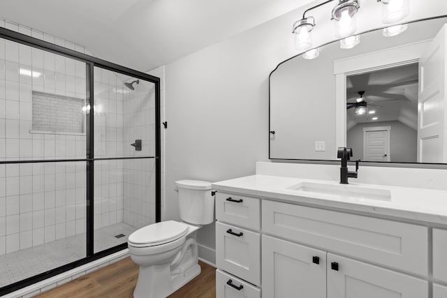 bathroom with walk in shower, hardwood / wood-style floors, vanity, and ceiling fan