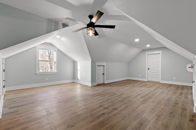 bonus room featuring light wood-type flooring, ceiling fan, and lofted ceiling