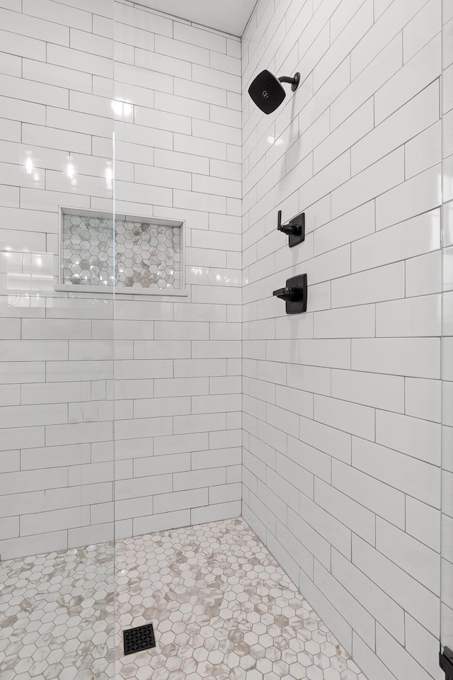 bathroom with tiled shower