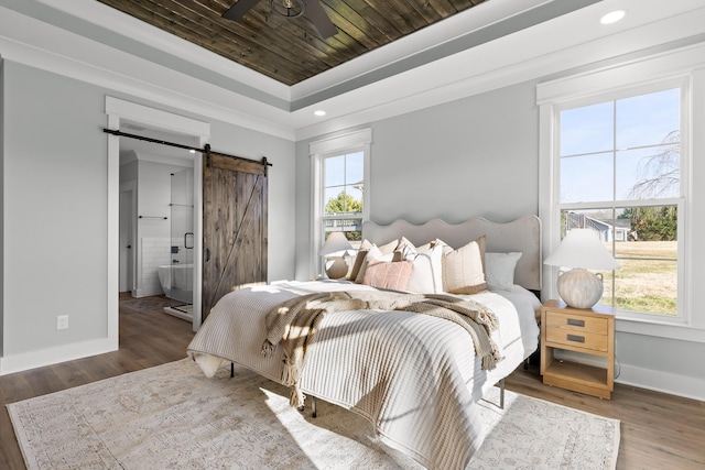 bedroom featuring ensuite bathroom, dark hardwood / wood-style floors, a barn door, a tray ceiling, and wood ceiling