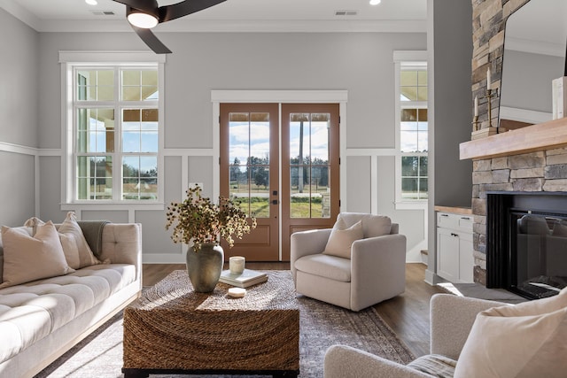 living room with a fireplace, french doors, dark hardwood / wood-style flooring, and ornamental molding