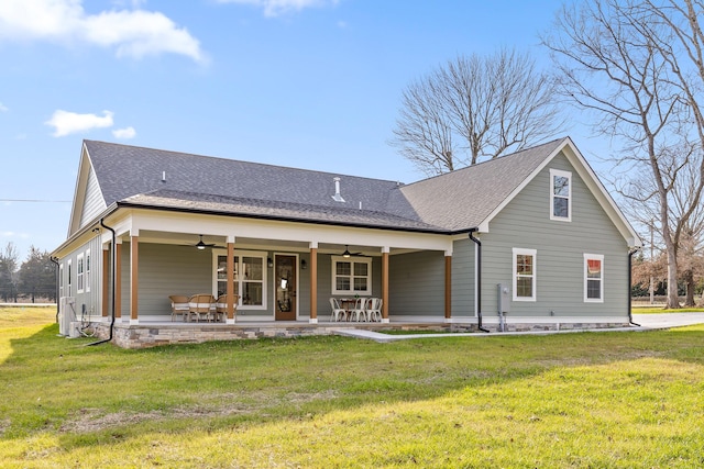 back of property with a patio, ceiling fan, and a lawn