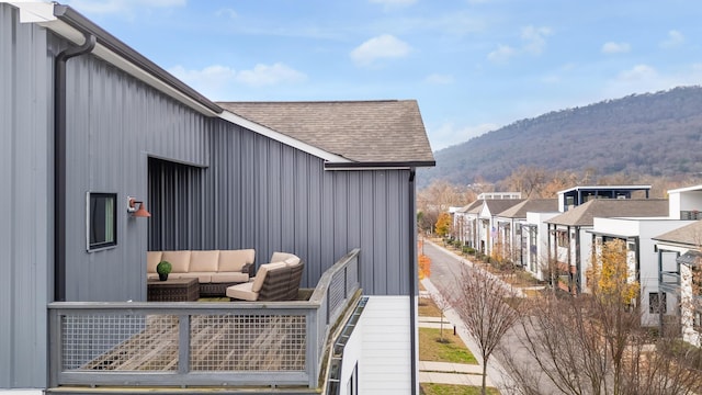 view of side of home with an outdoor hangout area, a mountain view, and a balcony