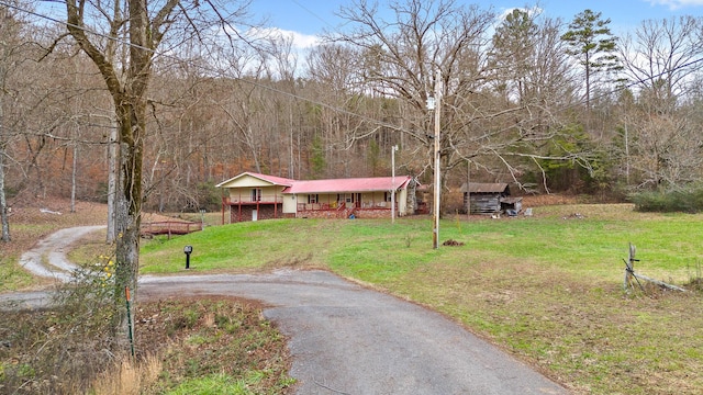 view of front of home with a front yard and covered porch