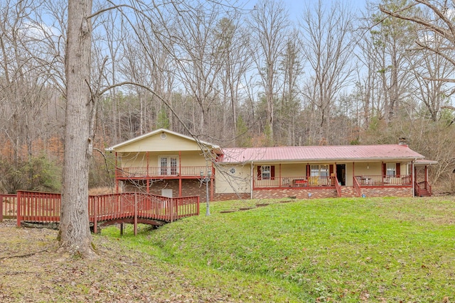 view of front of house with a front lawn and a wooden deck