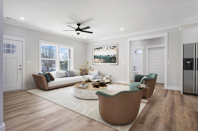 living room featuring ceiling fan, light hardwood / wood-style flooring, and crown molding