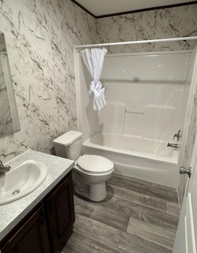 full bathroom with wood finished floors, vanity, toilet, and shower / bath combo with shower curtain