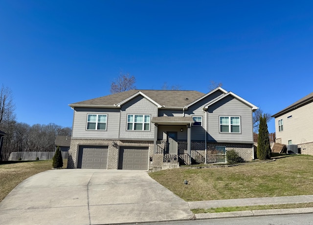 split foyer home featuring a front yard and a garage