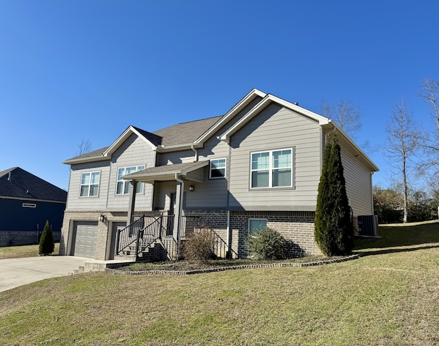 view of front of property with a front yard, central AC, and a garage