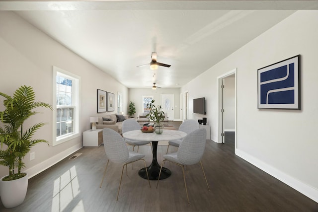 dining space with ceiling fan and dark hardwood / wood-style floors