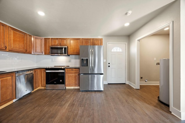 kitchen featuring backsplash, stainless steel appliances, and dark wood-type flooring