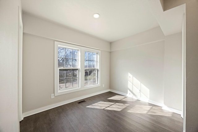 empty room with dark wood-type flooring