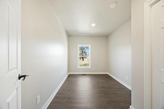 spare room featuring dark wood-type flooring