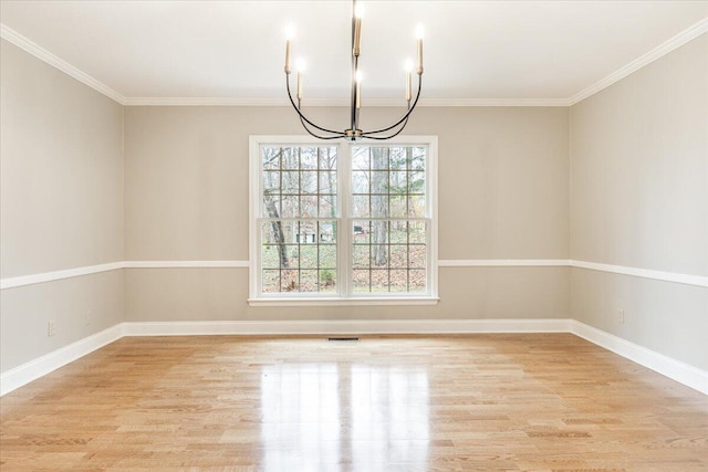 unfurnished dining area with crown molding, light hardwood / wood-style flooring, and a notable chandelier