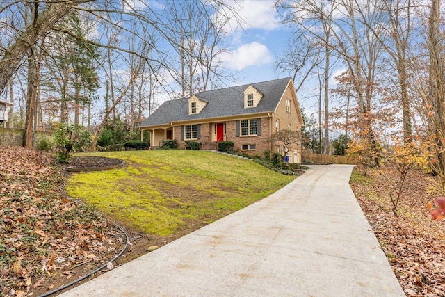 cape cod house with a front lawn