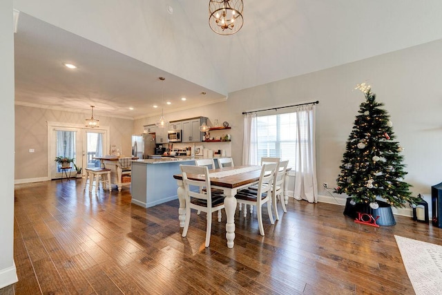 dining room featuring dark hardwood / wood-style flooring, a healthy amount of sunlight, and an inviting chandelier