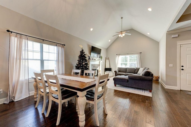 dining room featuring dark hardwood / wood-style flooring, high vaulted ceiling, and ceiling fan