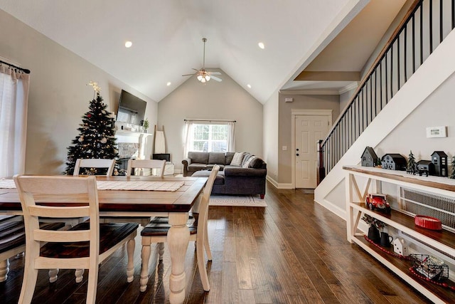 dining area featuring ceiling fan, wood-type flooring, and vaulted ceiling