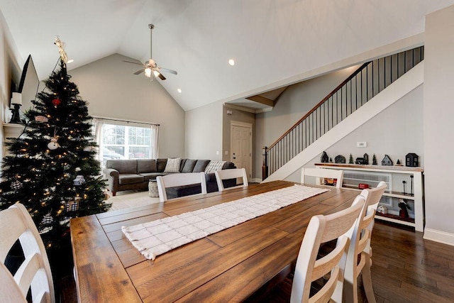 dining room with dark hardwood / wood-style floors, high vaulted ceiling, and ceiling fan