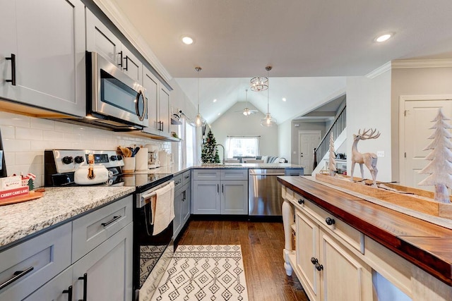 kitchen featuring gray cabinetry, sink, vaulted ceiling, tasteful backsplash, and stainless steel appliances