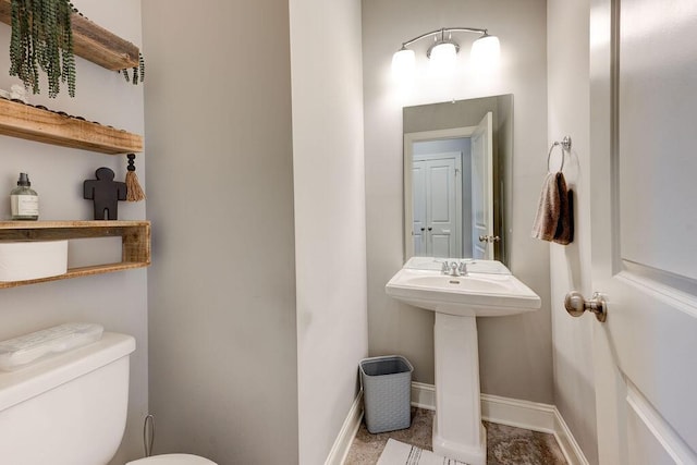 bathroom featuring sink and toilet