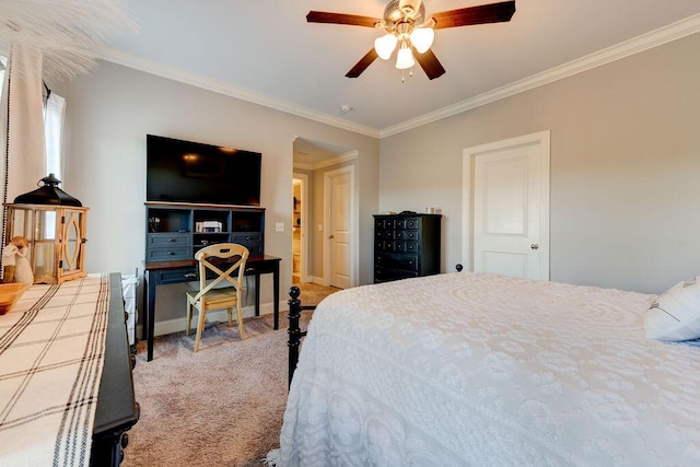 carpeted bedroom with ceiling fan and ornamental molding